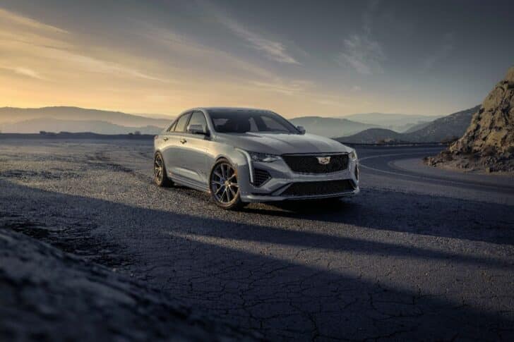 Front view of the 2024 Cadillac CT4-V in Argent Silver Metallic with mountains in the background