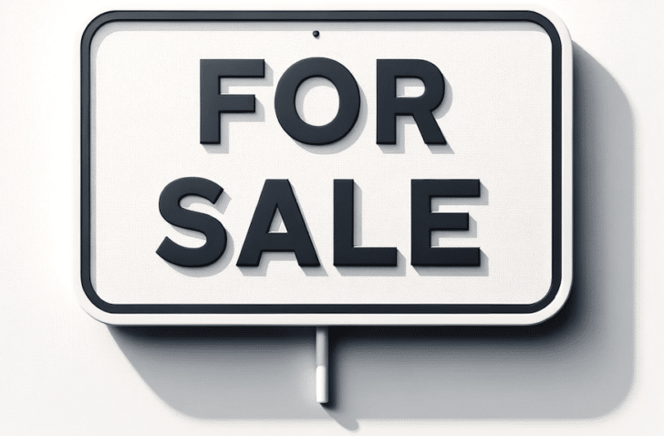A picture of a white sign with "For Sale" in black letters