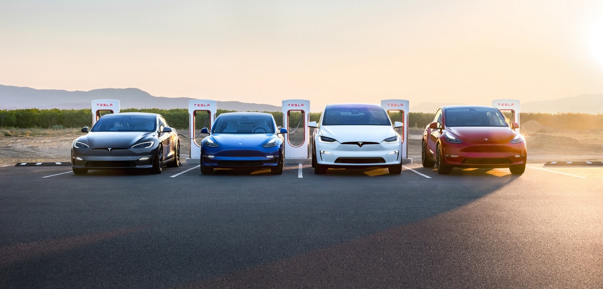 Four Tesla cars at a supercharger