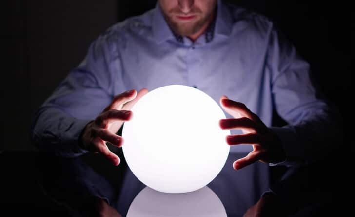 A person with his hands on a crystal ball
