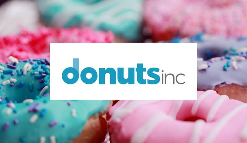 Donuts Inc logo on a picture of donuts