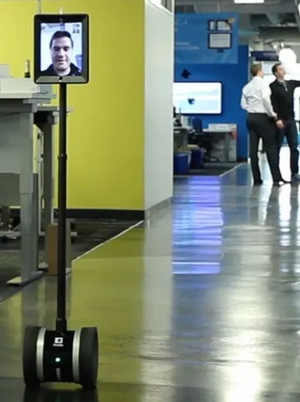 Picture of a robot at a tradeshow with a virtual remote operator