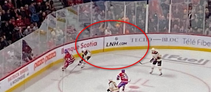 Picture of LNH.com advertisement on the boards at a hockey game between the Montreal Canadiens and Boston Bruins