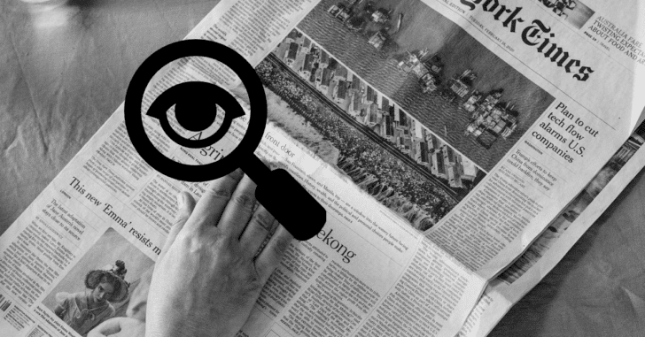 A magnifying glass image over a copy of The New York Times