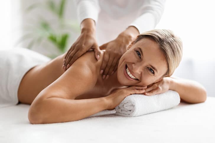 Image of woman lying on table getting a massage.
