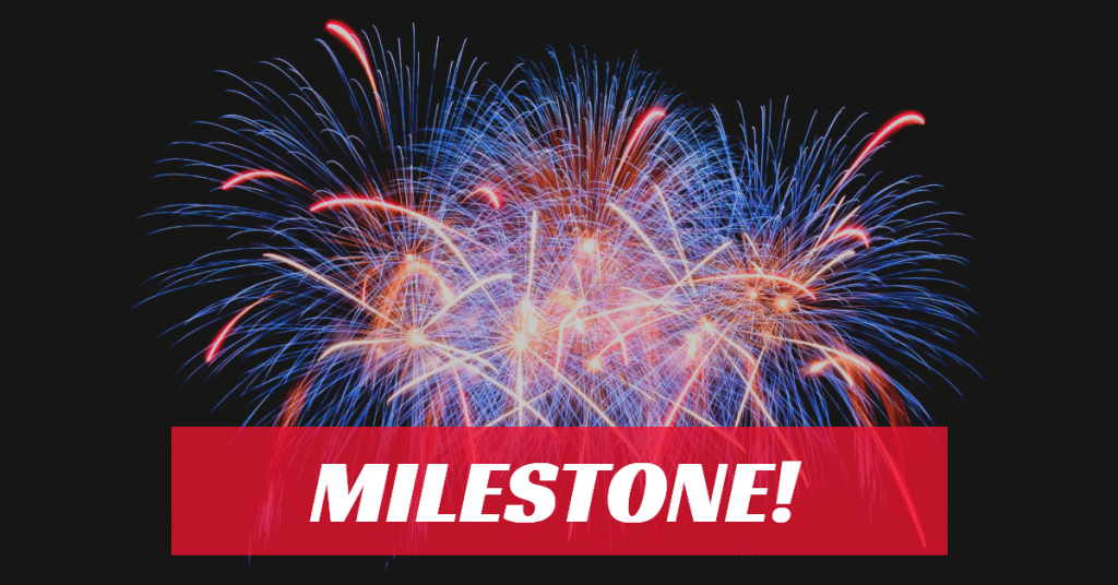 Picture of red, blue and yellow fireworks with the word "milestone" in white letters on a red background.