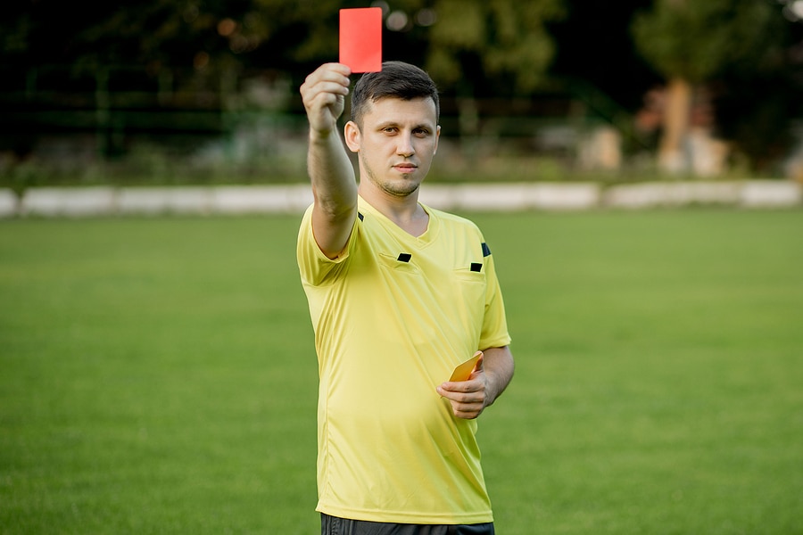 Picture of soccer referee holding up a red card