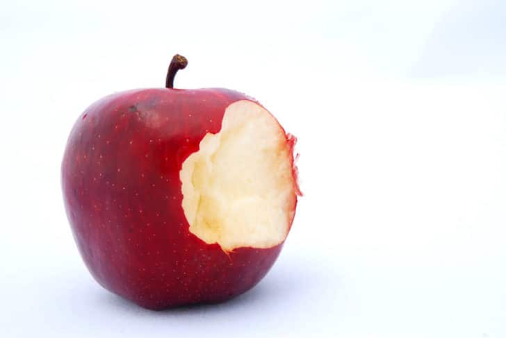 Picture of red apple with big bite taken