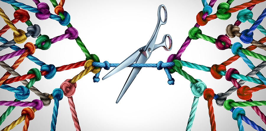 Image of links tied together with scissors cutting the connection
