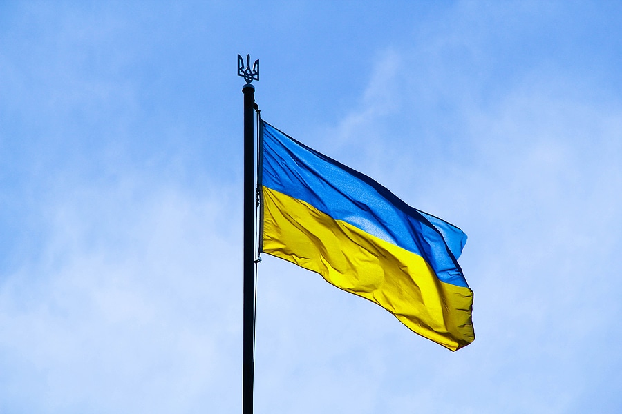Ukraine flag with blue top and yellow bottom flying on a flagpole