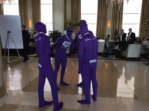 People in purple leotards promoting .xyz